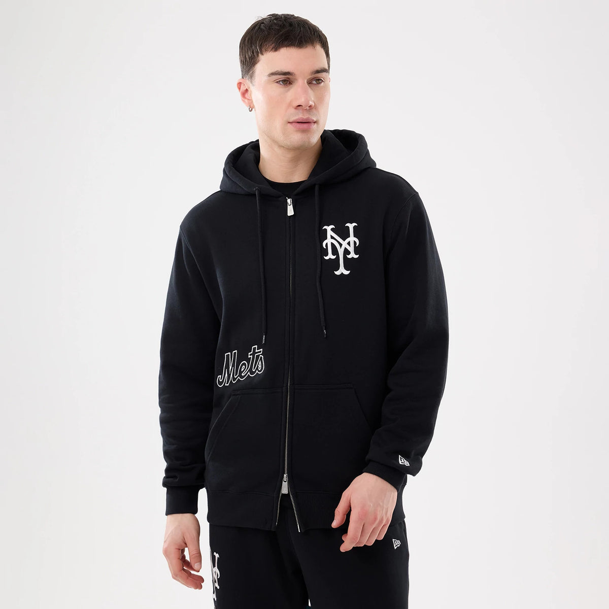 The model is wearing this MLB Comfort New York Mets 2 Way Full Zip Hoodie in black. 1