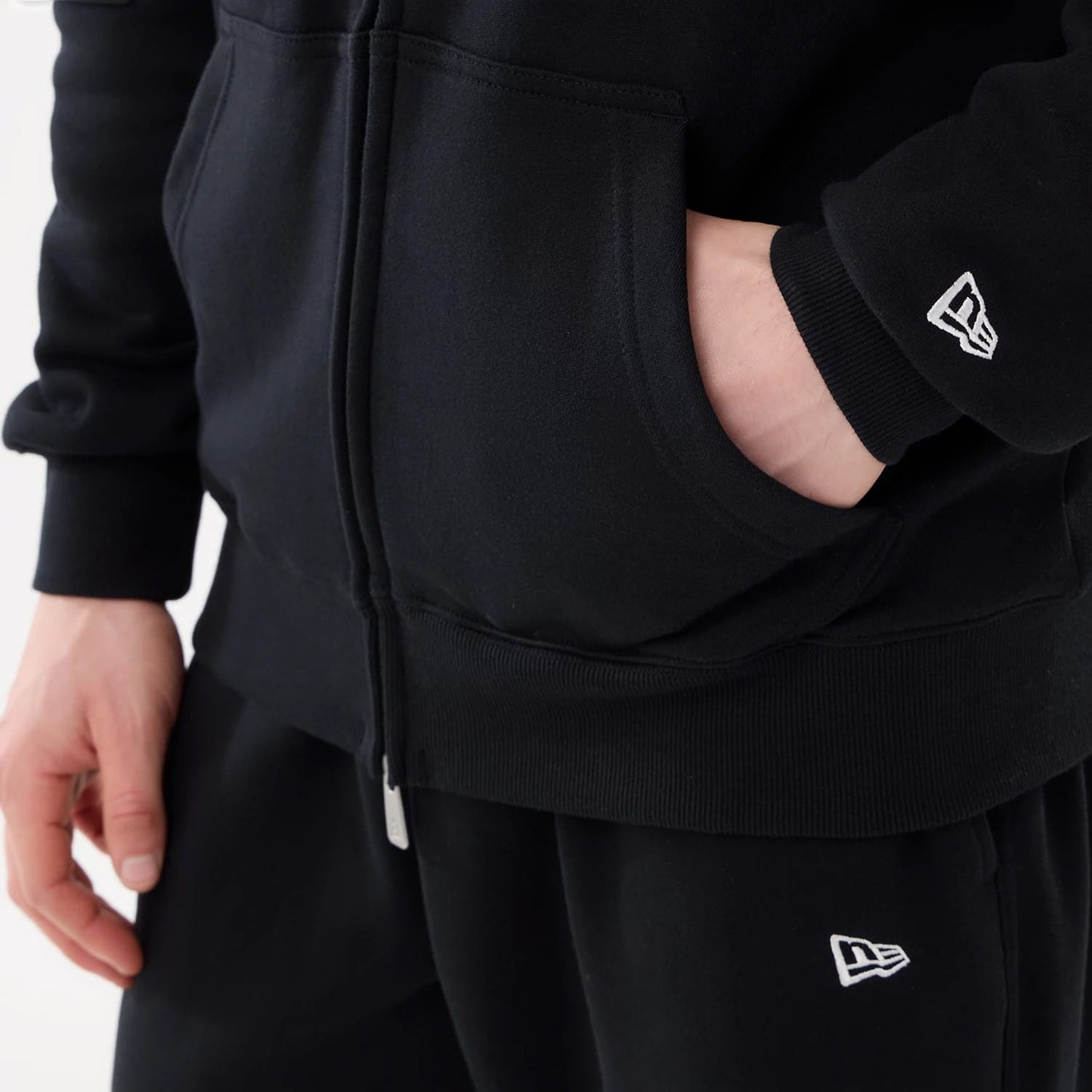 The model is wearing this MLB Comfort New York Mets 2 Way Full Zip Hoodie in black. 6