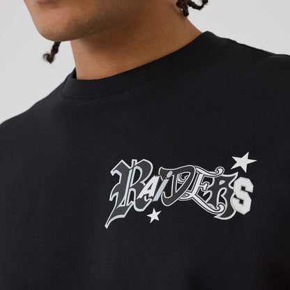 Las Vegas Raiders NFL Word Art Black T-Shirt, side view showing the black fabric with an embossed Raiders word art logo in white and grey on the upper chest, featuring two stars surrounding the text.