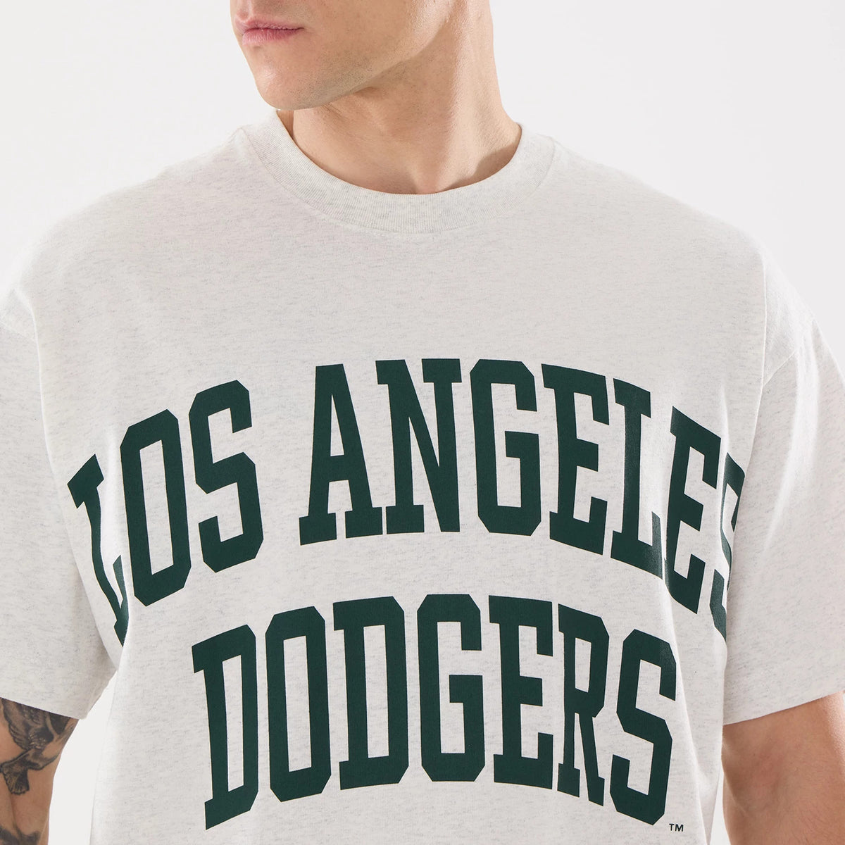 New Era LA Dodgers MLB Comfort Grey T-Shirt, front view featuring bold black Los Angeles Dodgers text across the chest on a light grey background, with a ribbed neckline at the top.