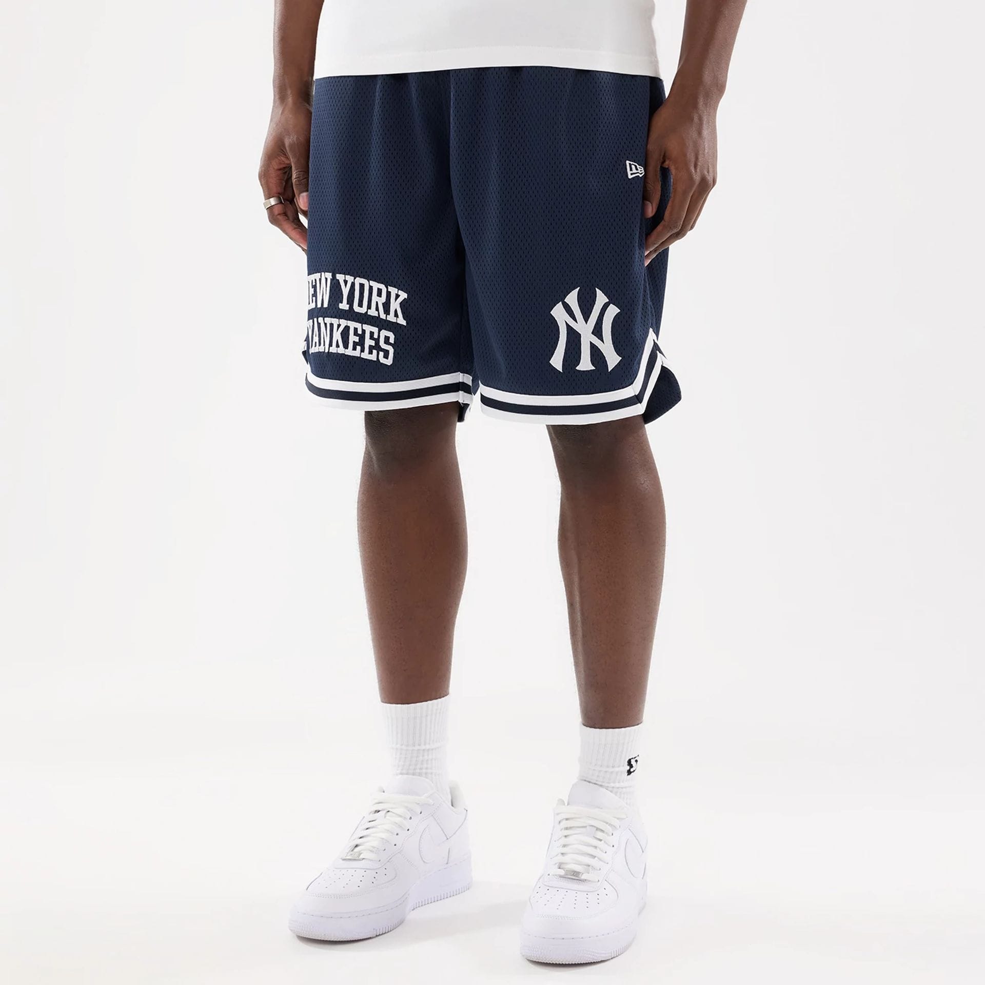 The model is wearing this MLB Comfort New York Yankees Oversized Shorts in navy. 1