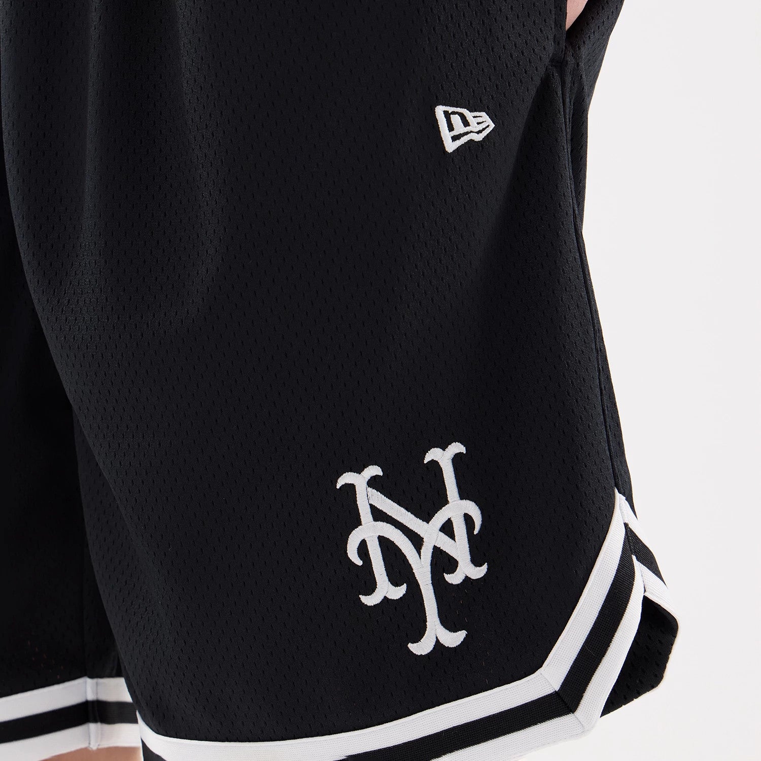 The model is wearing this MLB Comfort New York Mets Oversized Shorts in navy. 4