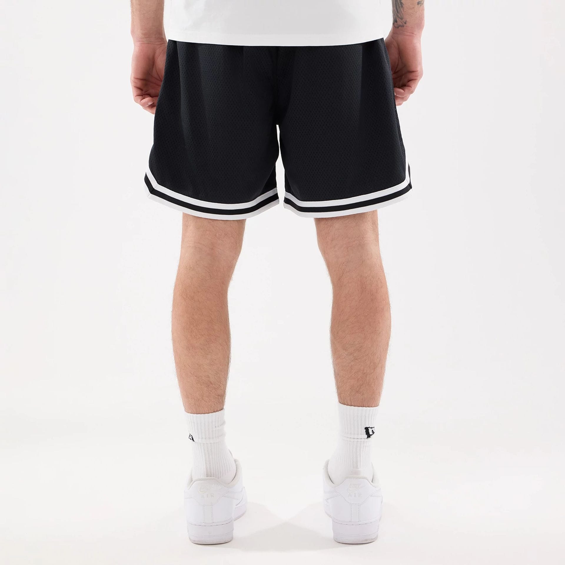 The model is wearing this MLB Comfort New York Mets Oversized Shorts in navy. 2