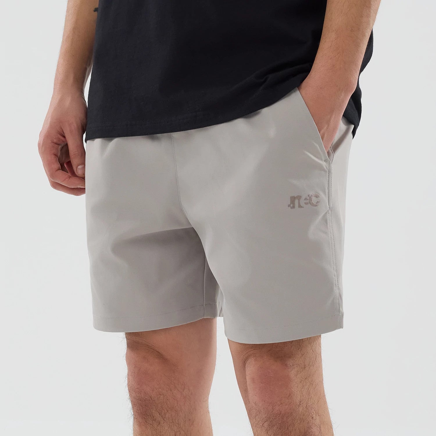 The model is wearing this New Era NEC Logo Oversized Shorts in Beige . 3