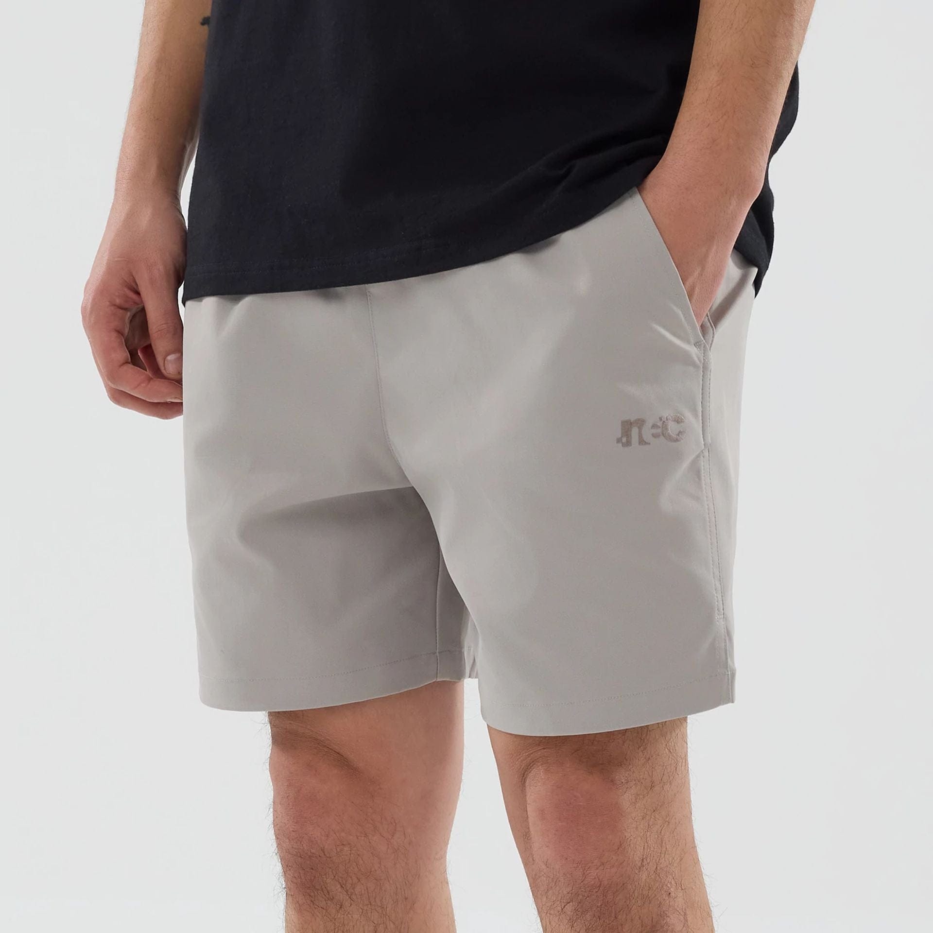The model is wearing this New Era NEC Logo Oversized Shorts in Beige . 3