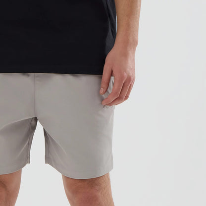 The model is wearing this New Era NEC Logo Oversized Shorts in Beige . 5