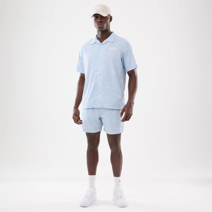 The model is wearing this New Era Resort Short Sleeve Shirt in blue. 8