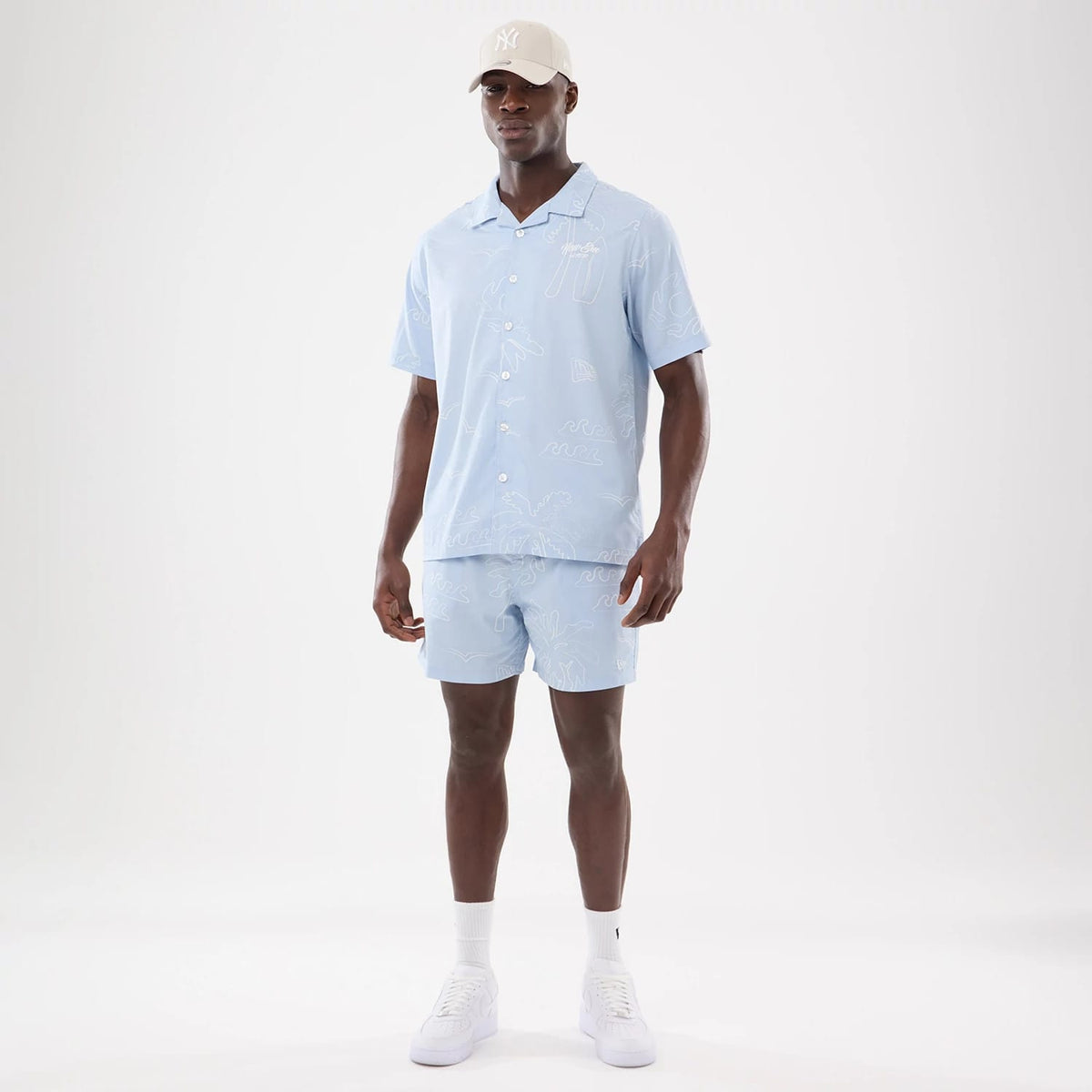 The model is wearing this New Era Resort Short Sleeve Shirt in blue. 8