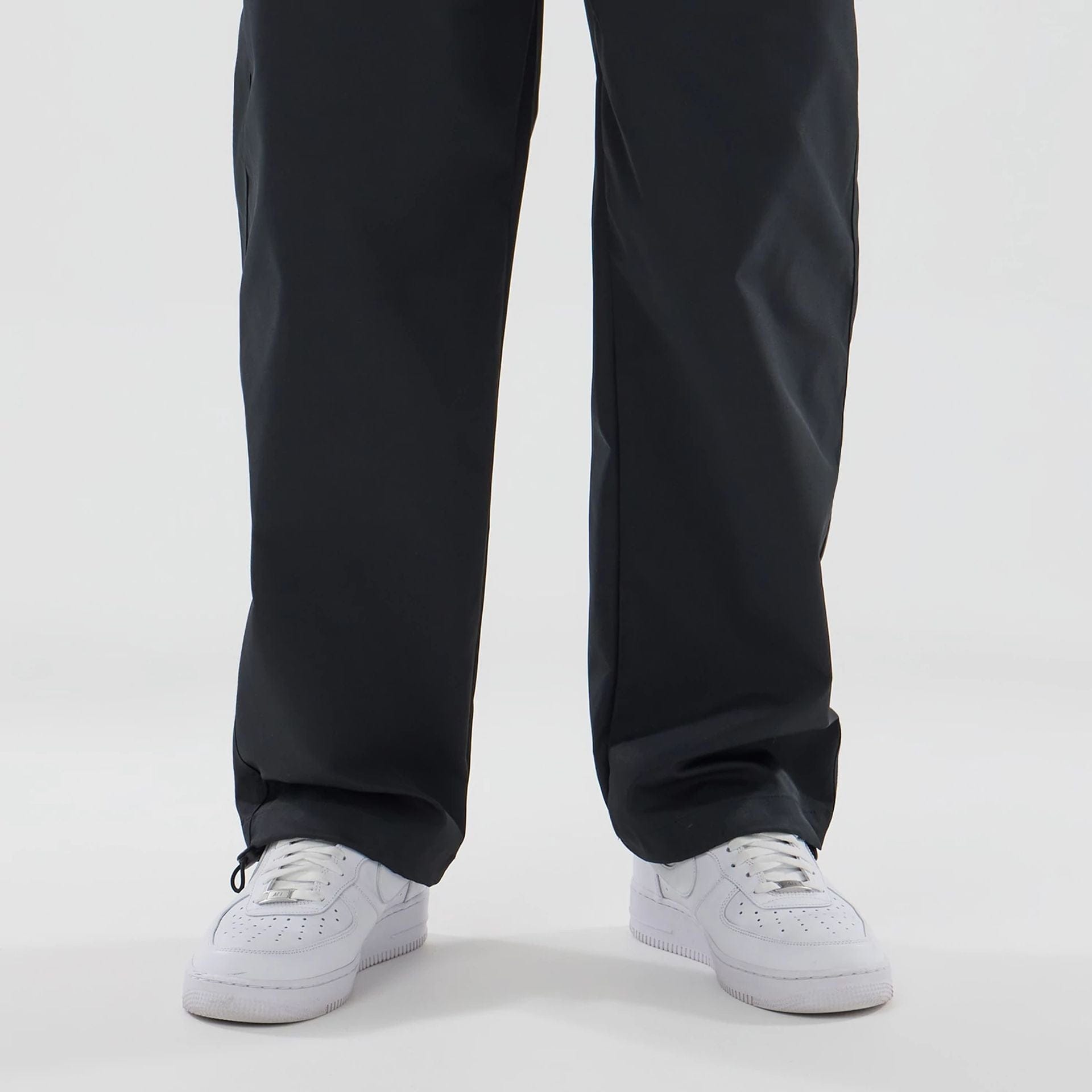 The model is wearing this New Era NEC Logo Straight Leg Joggers in black. 4