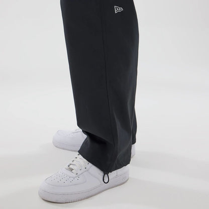 The model is wearing this New Era NEC Logo Straight Leg Joggers in black. 5