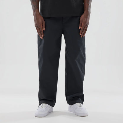The model is wearing this New Era NEC Logo Straight Leg Joggers in black. 1