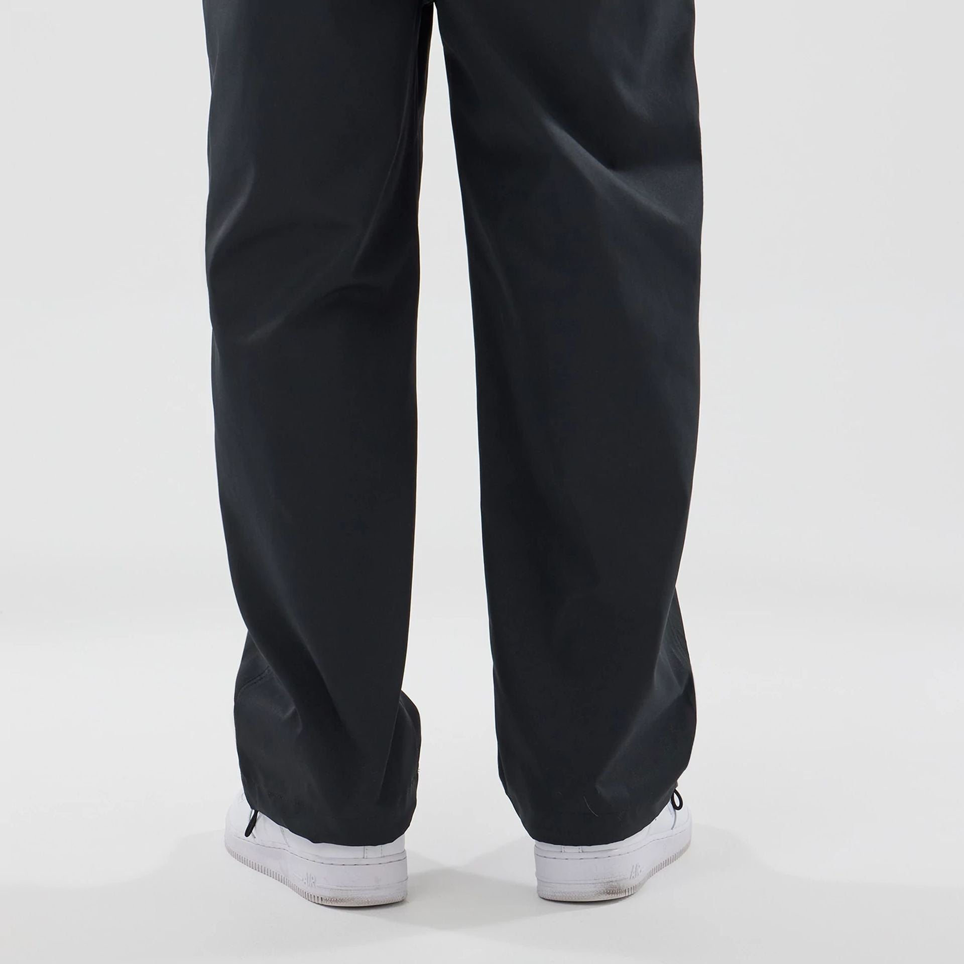 The model is wearing this New Era NEC Logo Straight Leg Joggers in black. 6