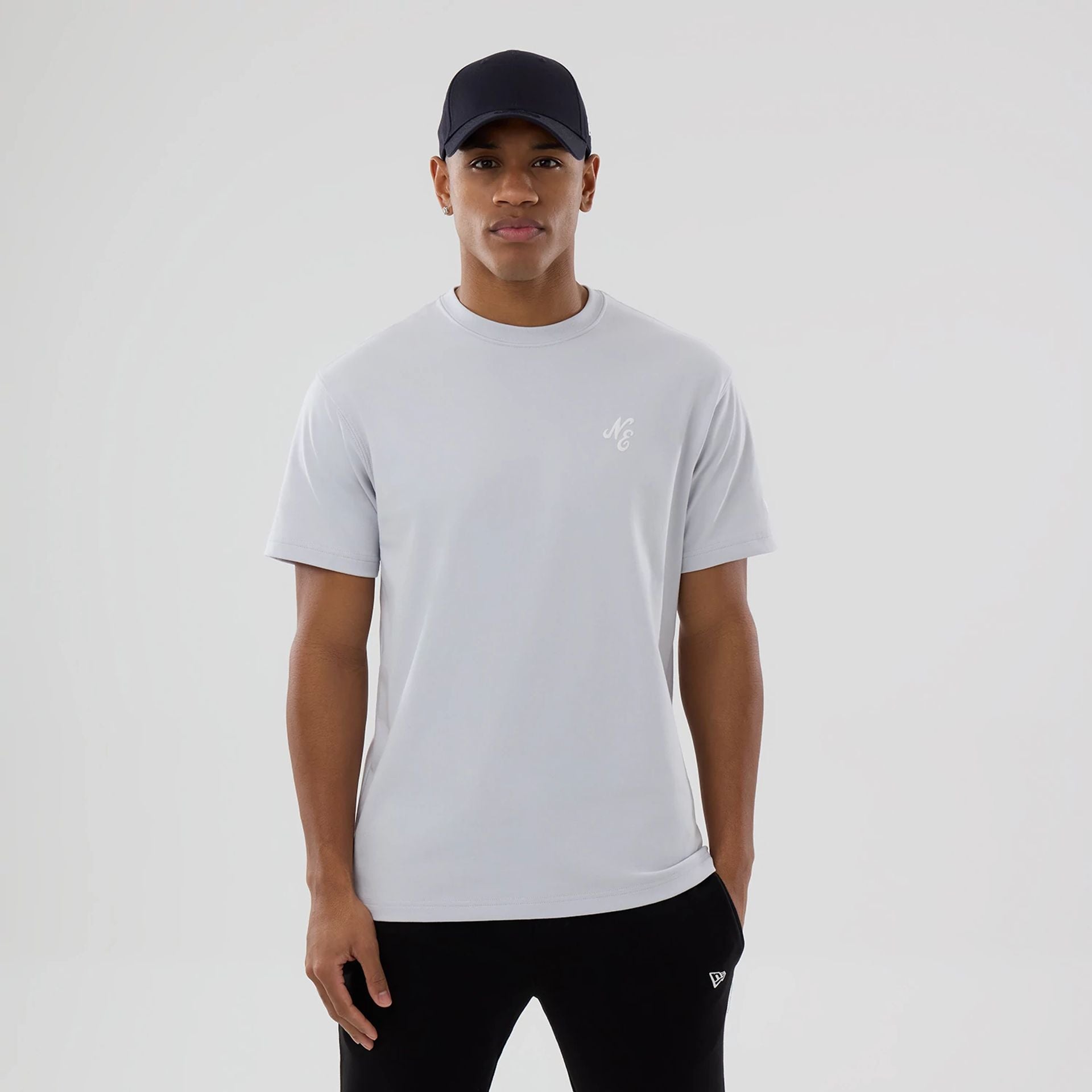 The model is wearing this New Era Zodiac Sign T-Shirt in silver. 1