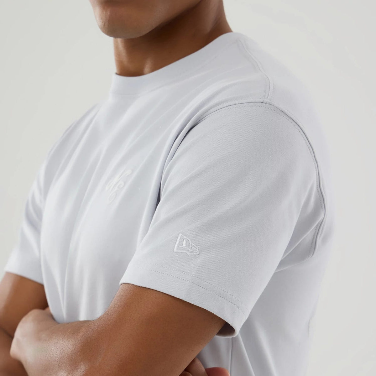 The model is wearing this New Era Zodiac Sign T-Shirt in silver. 6