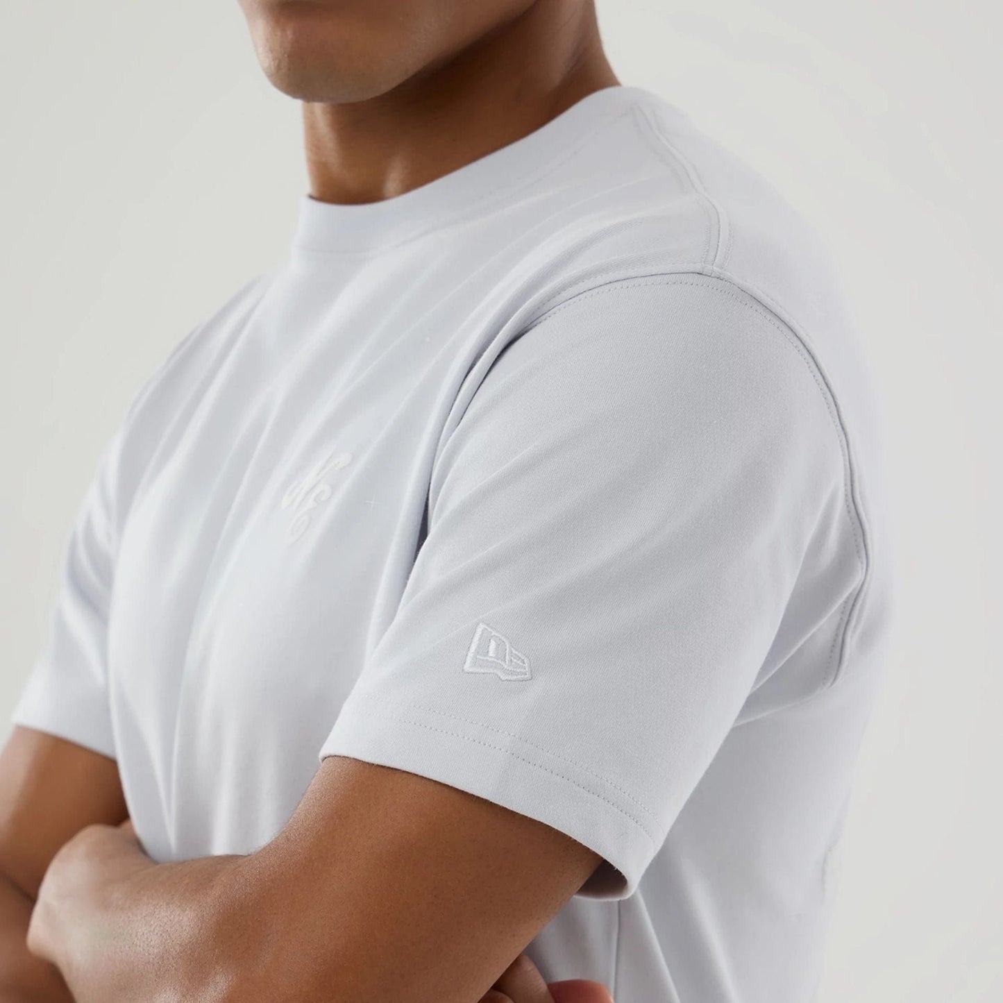 The model is wearing this New Era Zodiac Sign T-Shirt in silver. 6