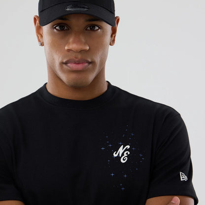 The model is wearing this New Era Zodiac Sign T-Shirt in black. 5