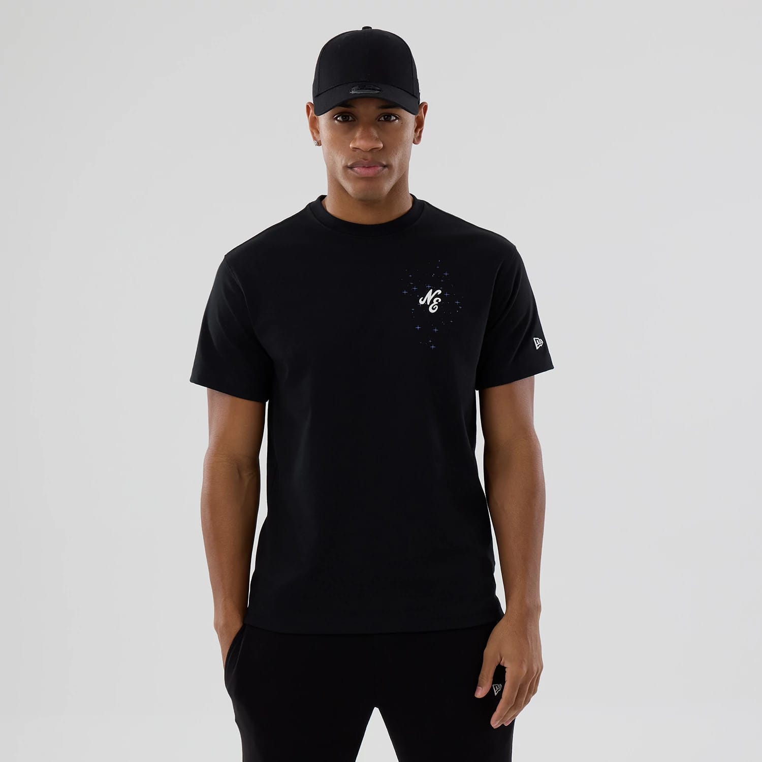 The model is wearing this New Era Zodiac Sign T-Shirt in black. 1