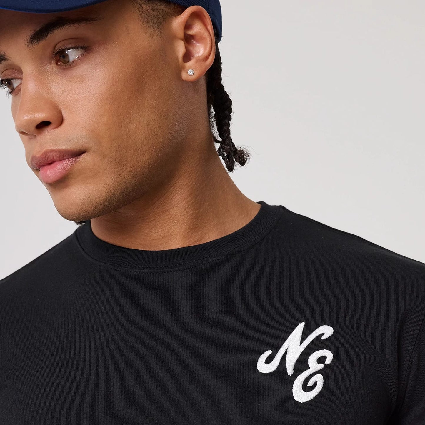 The model is wearing this New Era Sakura T-Shirt in black. 6