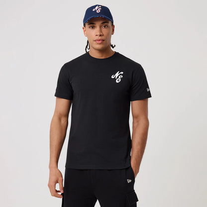 New Era Sakura Black T-Shirt, on-model view showing a man wearing a black T-shirt with a white raised logo on the chest, the New Era logo on the sleeve and a navy cap with the same logo on the front.
