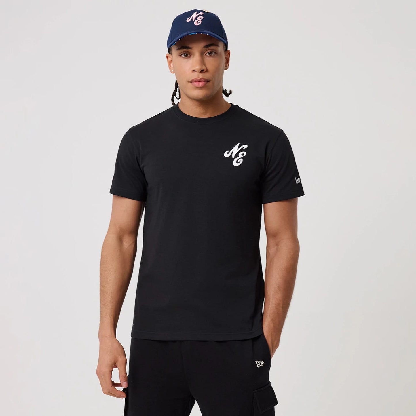 The model is wearing this New Era Sakura T-Shirt in black. 1