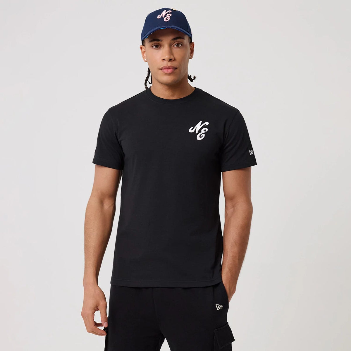 The model is wearing this New Era Sakura T-Shirt in black. 1
