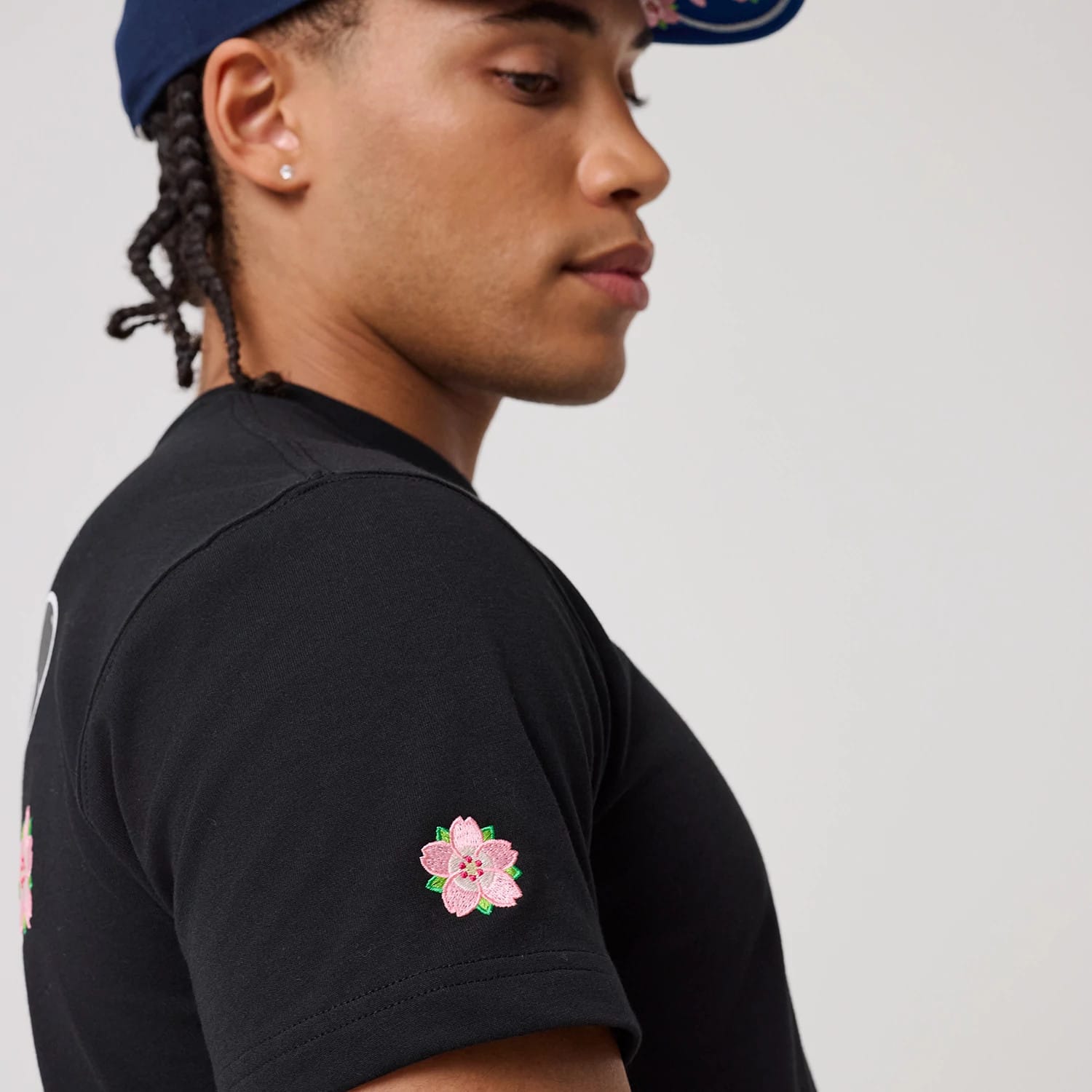 The model is wearing this New Era Sakura T-Shirt in black. 5