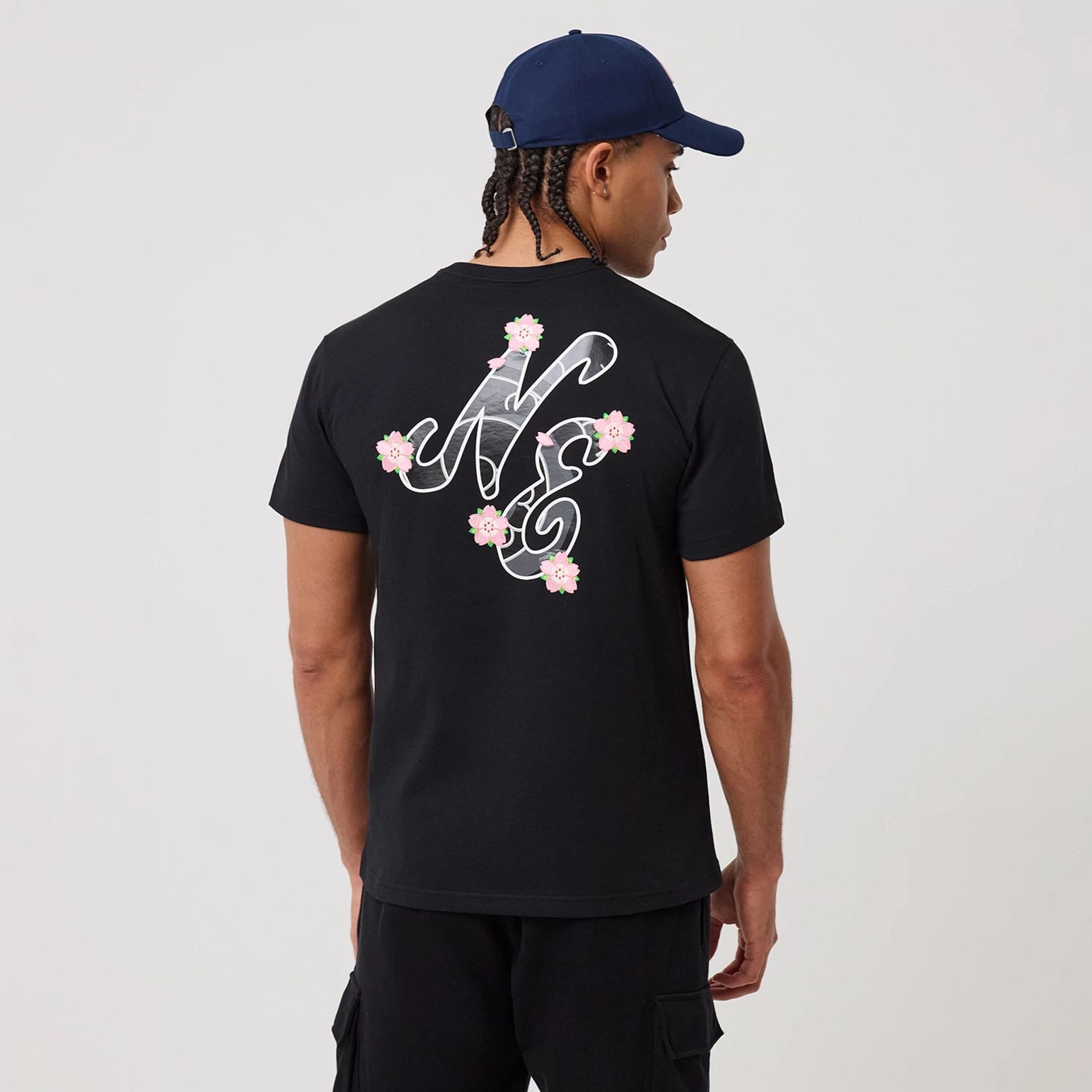 The model is wearing this New Era Sakura T-Shirt in black. 2