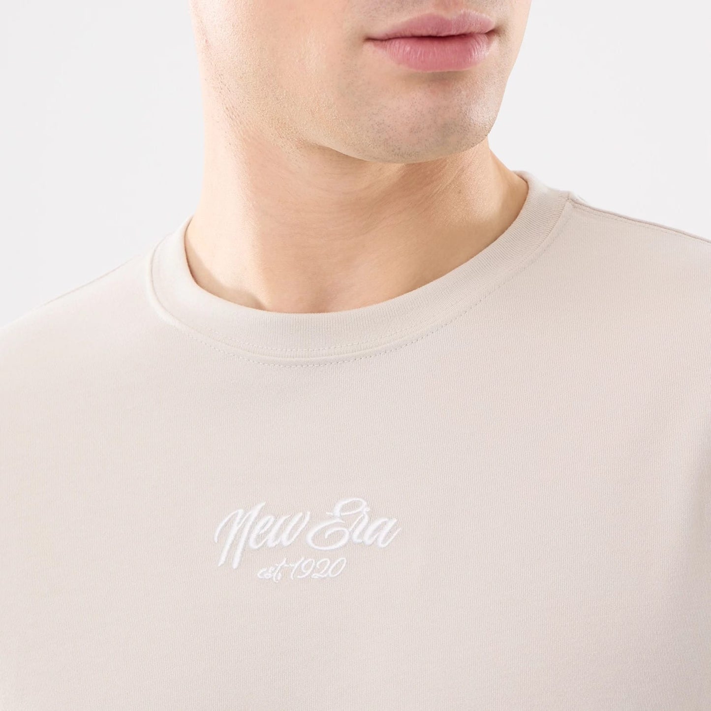 The model is wearing this New Era Resort T-Shirt in natural. 3