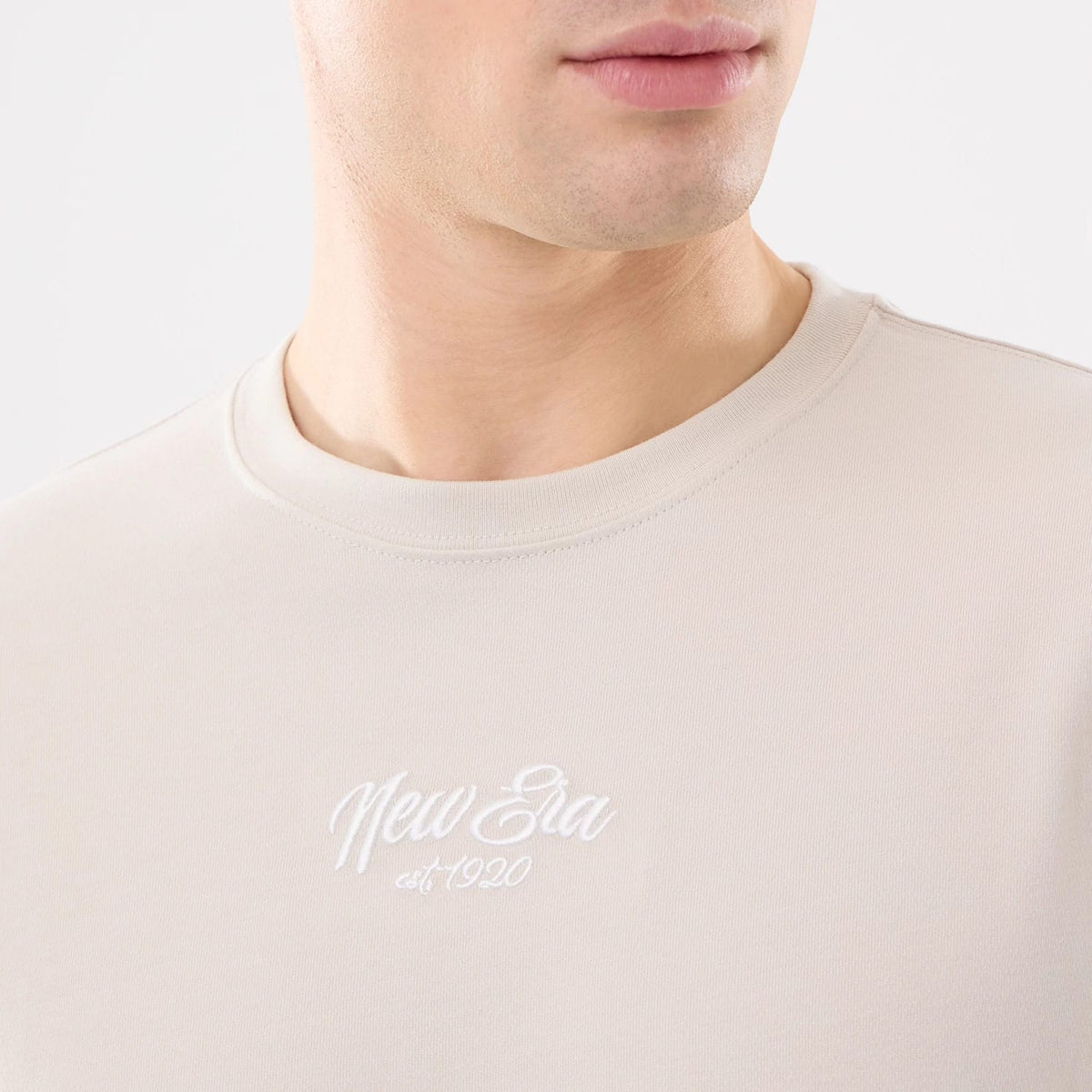 The model is wearing this New Era Resort T-Shirt in natural. 3