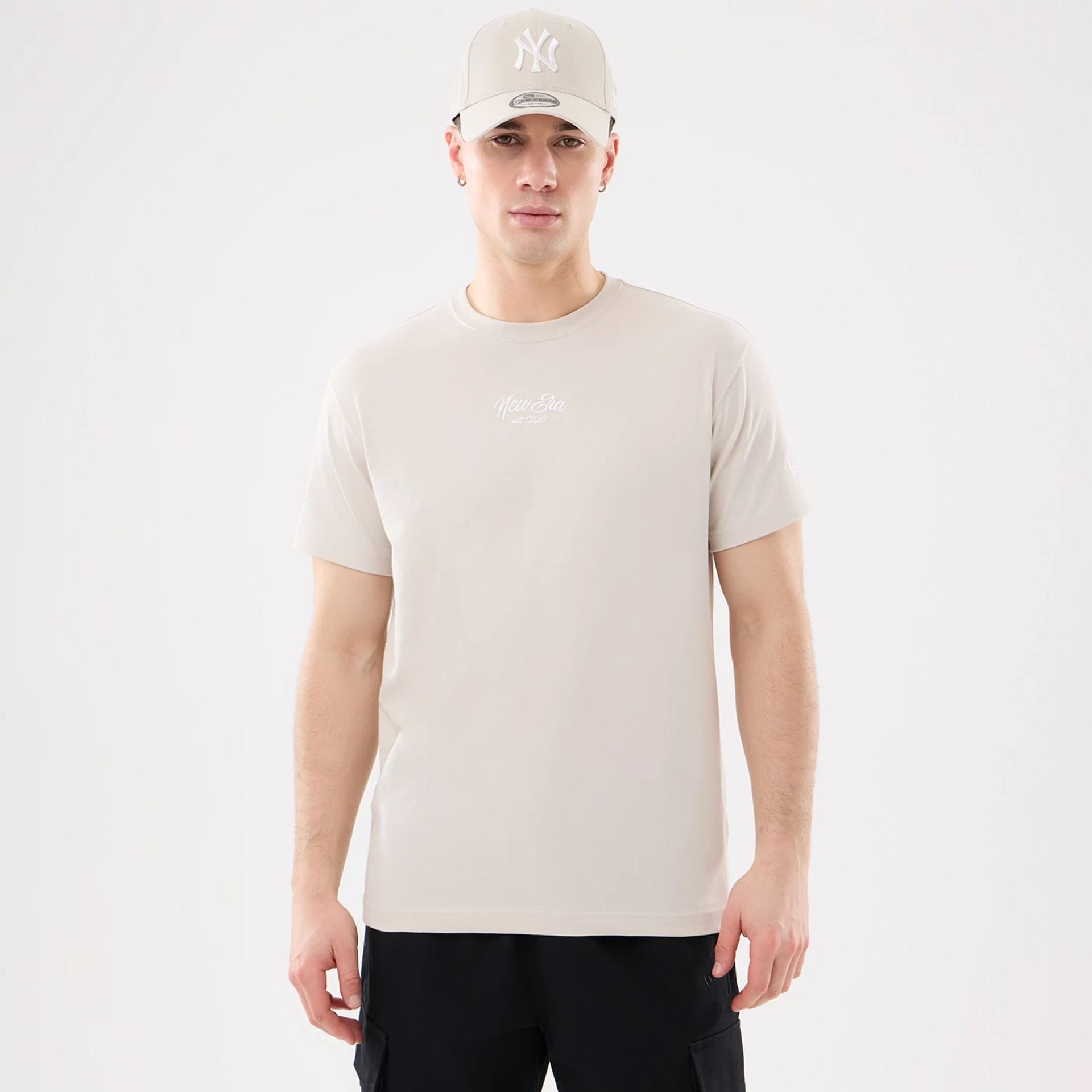 The model is wearing this New Era Resort T-Shirt in natural. 1