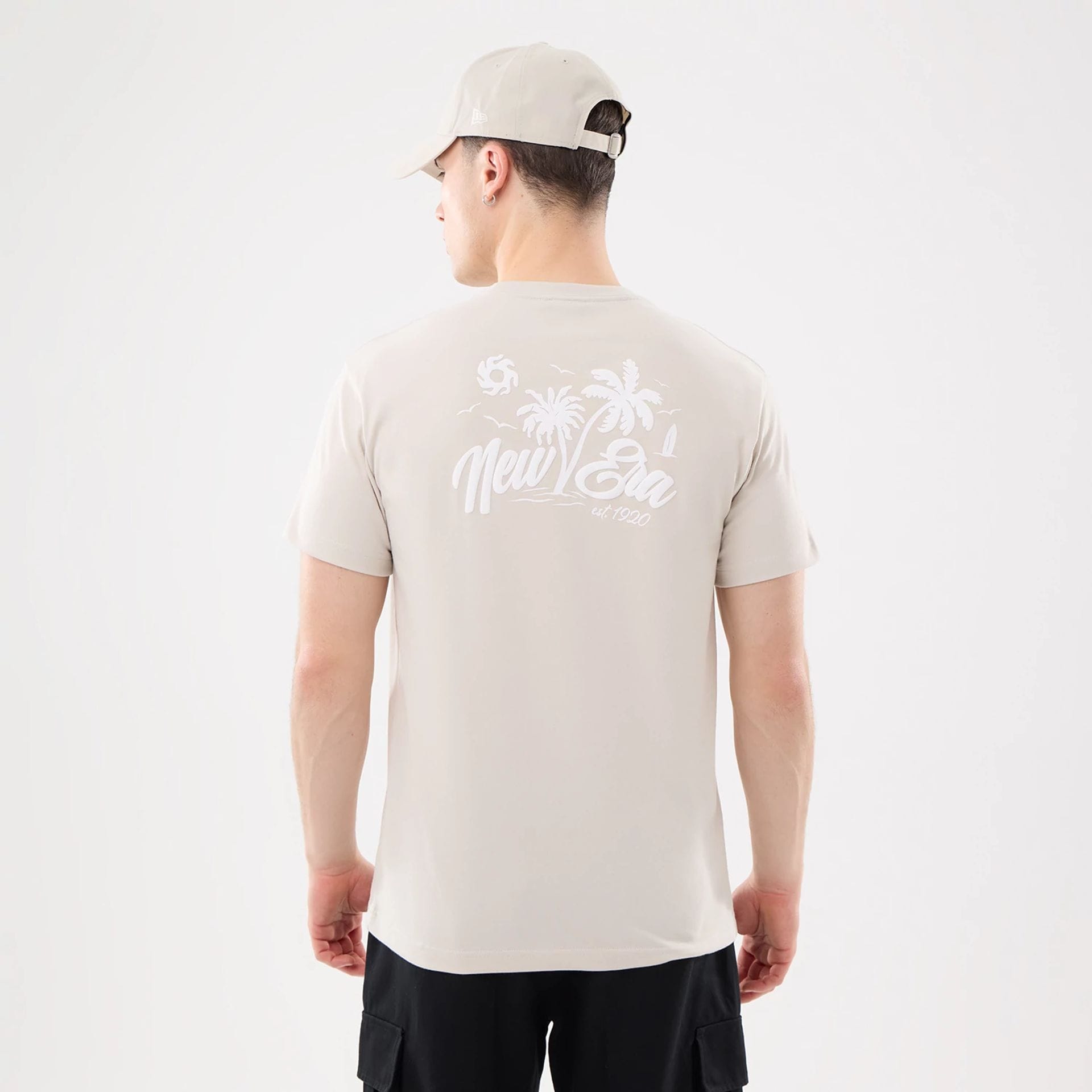 The model is wearing this New Era Resort T-Shirt in natural. 2