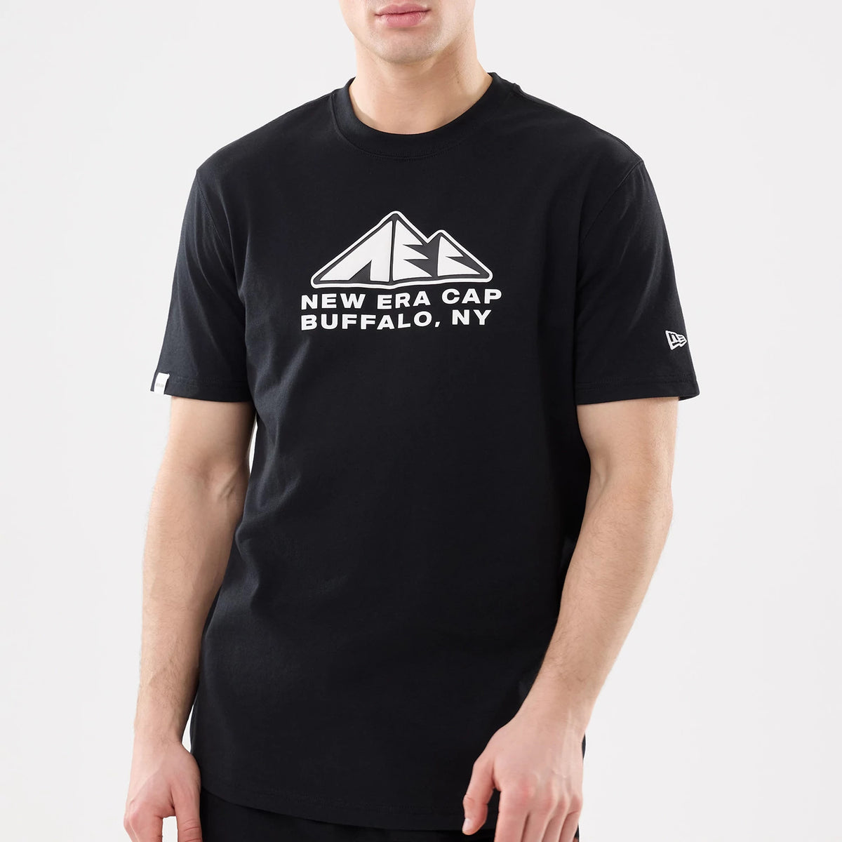 New Era Outdoor Mountain Black T-Shirt, front view showing a white mountain logo with "New Era Cap Buffalo, NY" text on the chest and a white embroidered New Era flag logo on the left sleeve.