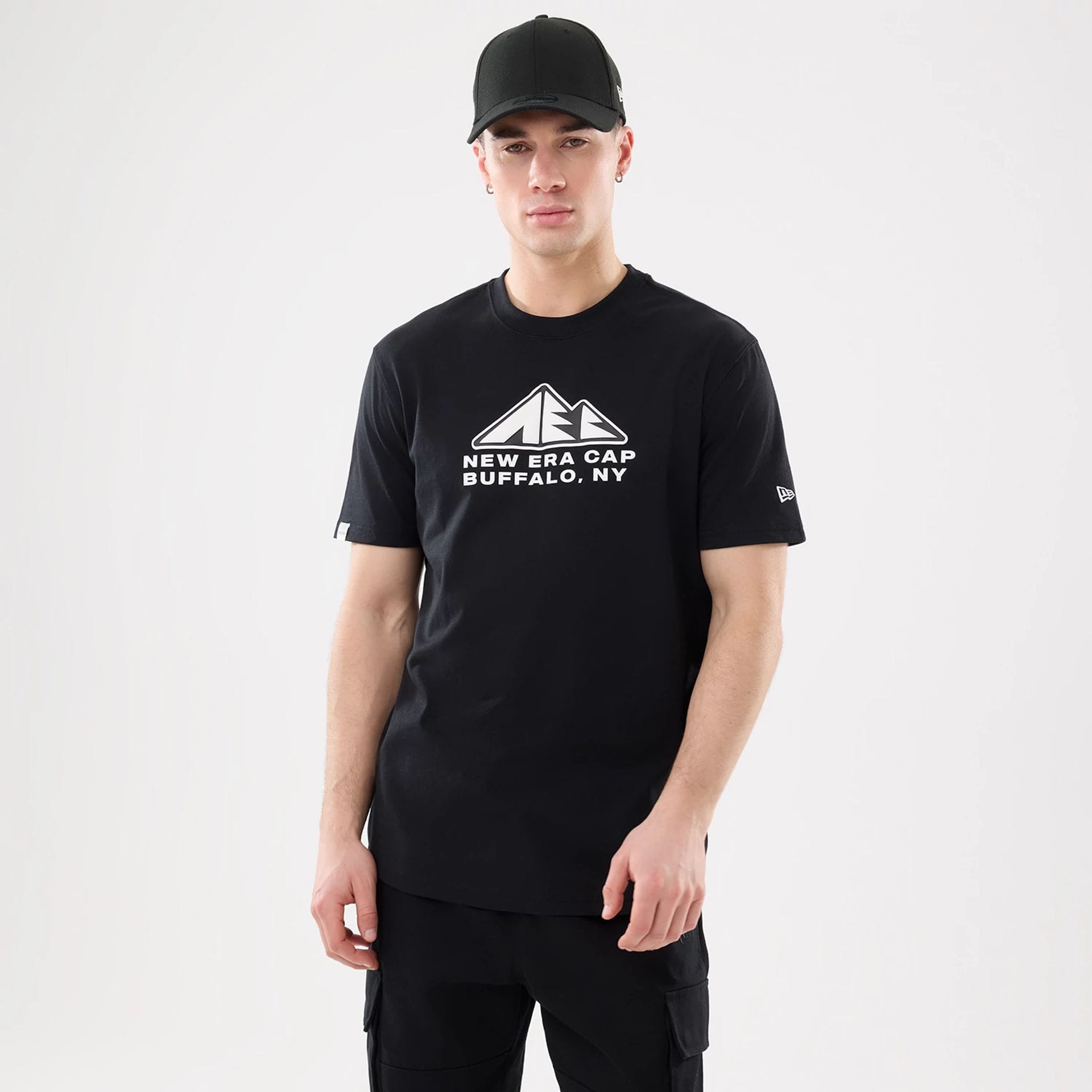 The model is wearing this New Era Outdoor Mountain T-Shirt in black. 1