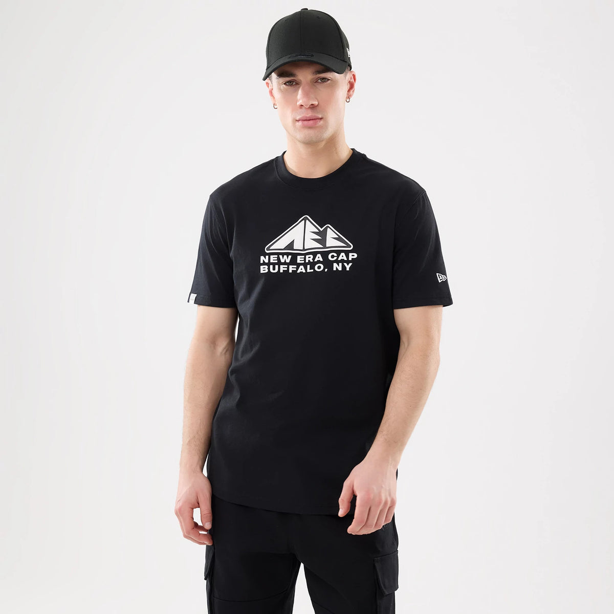 The model is wearing this New Era Outdoor Mountain T-Shirt in black. 1