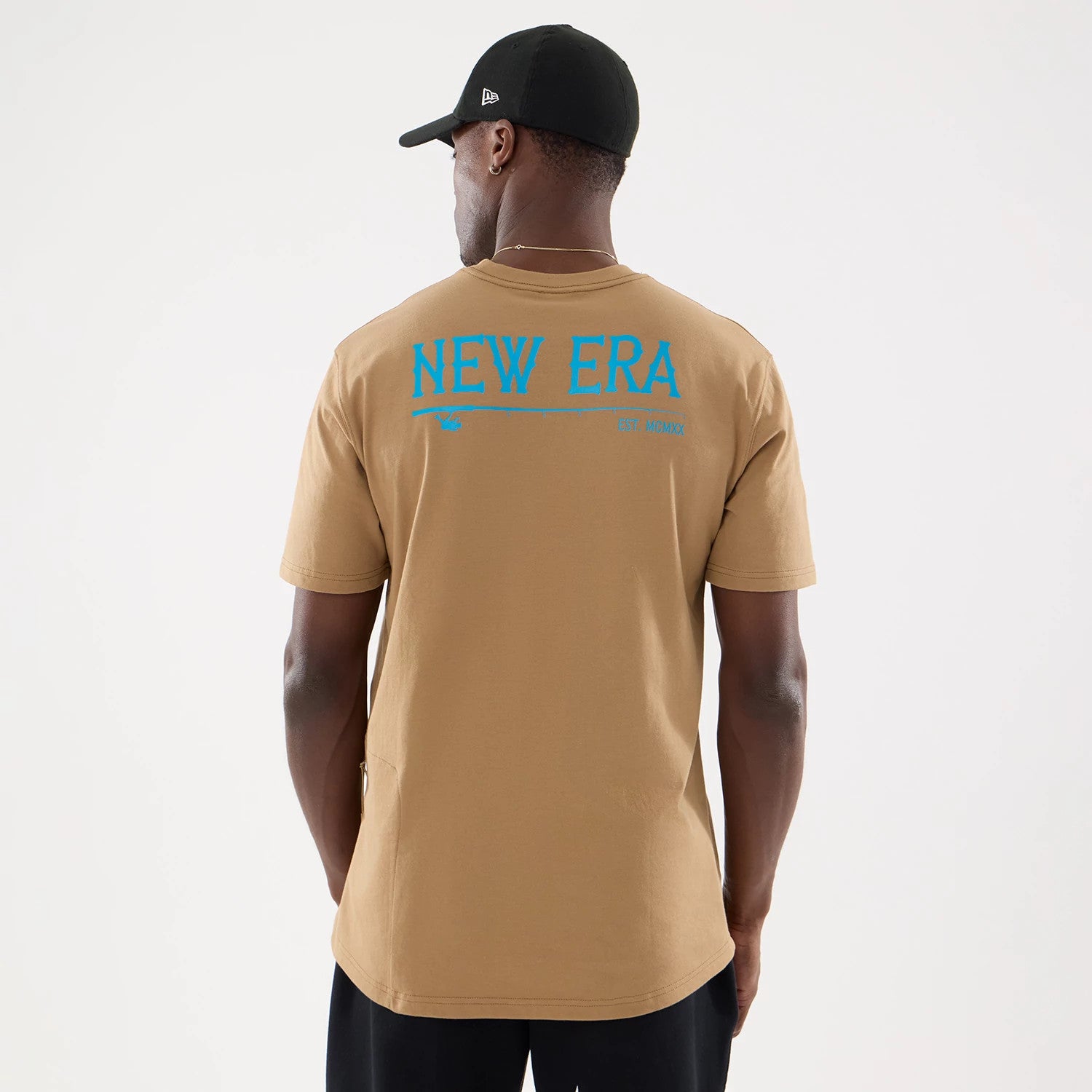 The model is wearing this New Era Outdoor Fishing T-Shirt in Beige. 2