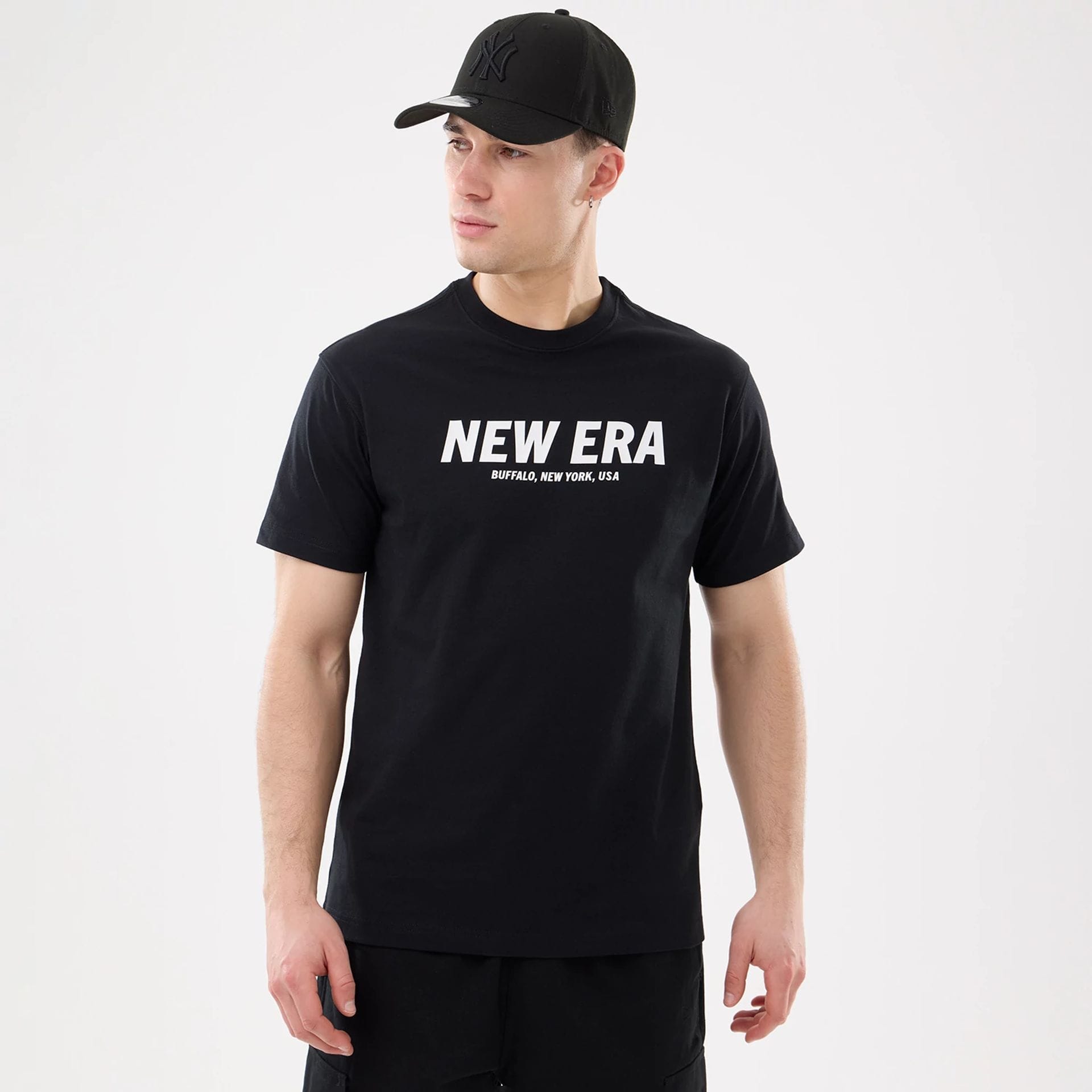 The model is wearing this New Era Basic T-Shirt in black. 1