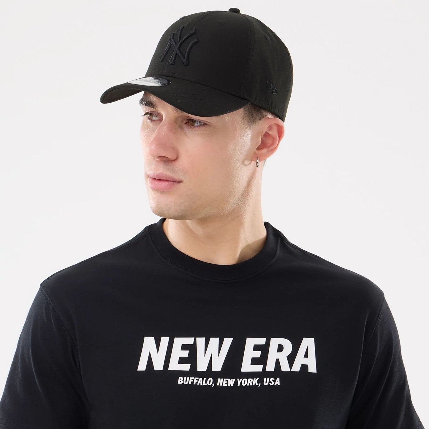The model is wearing this New Era Basic T-Shirt in black. 6