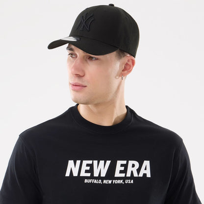 The model is wearing this New Era Basic T-Shirt in black. 6
