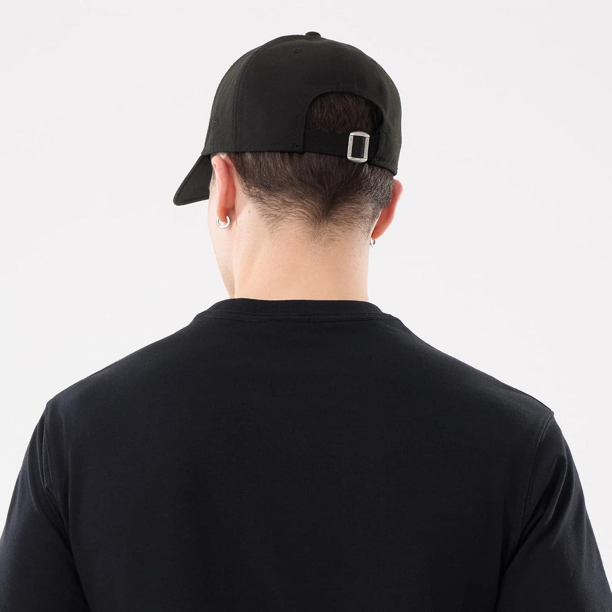 The model is wearing this New Era Basic T-Shirt in black. 7