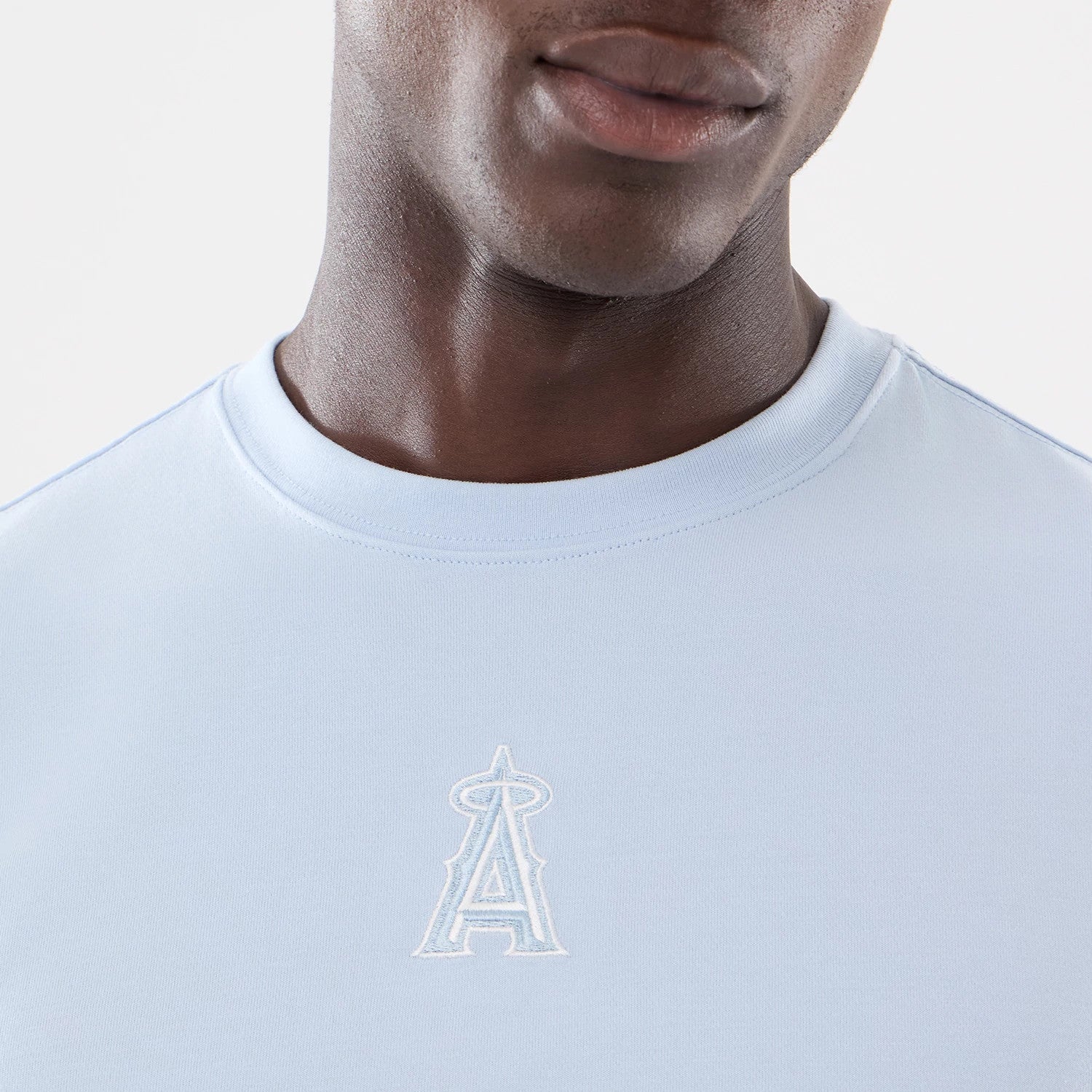 The model is wearing this MLB Cartoon LA Angels T-Shirt in blue. 3