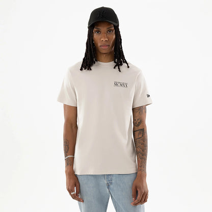 The model is wearing this New Era Heritage T-Shirt in Cream. 1