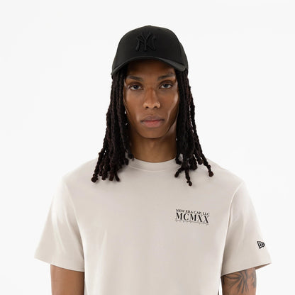 The model is wearing this New Era Heritage T-Shirt in Cream. 7