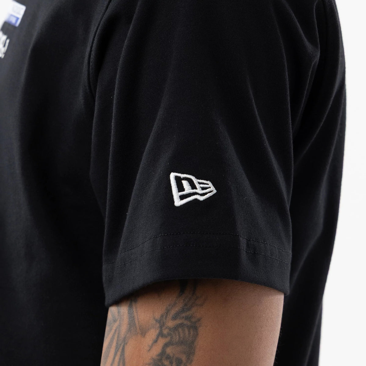 The model is wearing this New Era I Am Original T-Shirt in black. 5