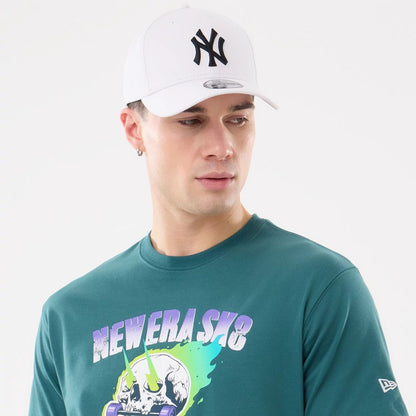 The model is wearing this New Era SK8 Graphic T-Shirt in dark green. 5