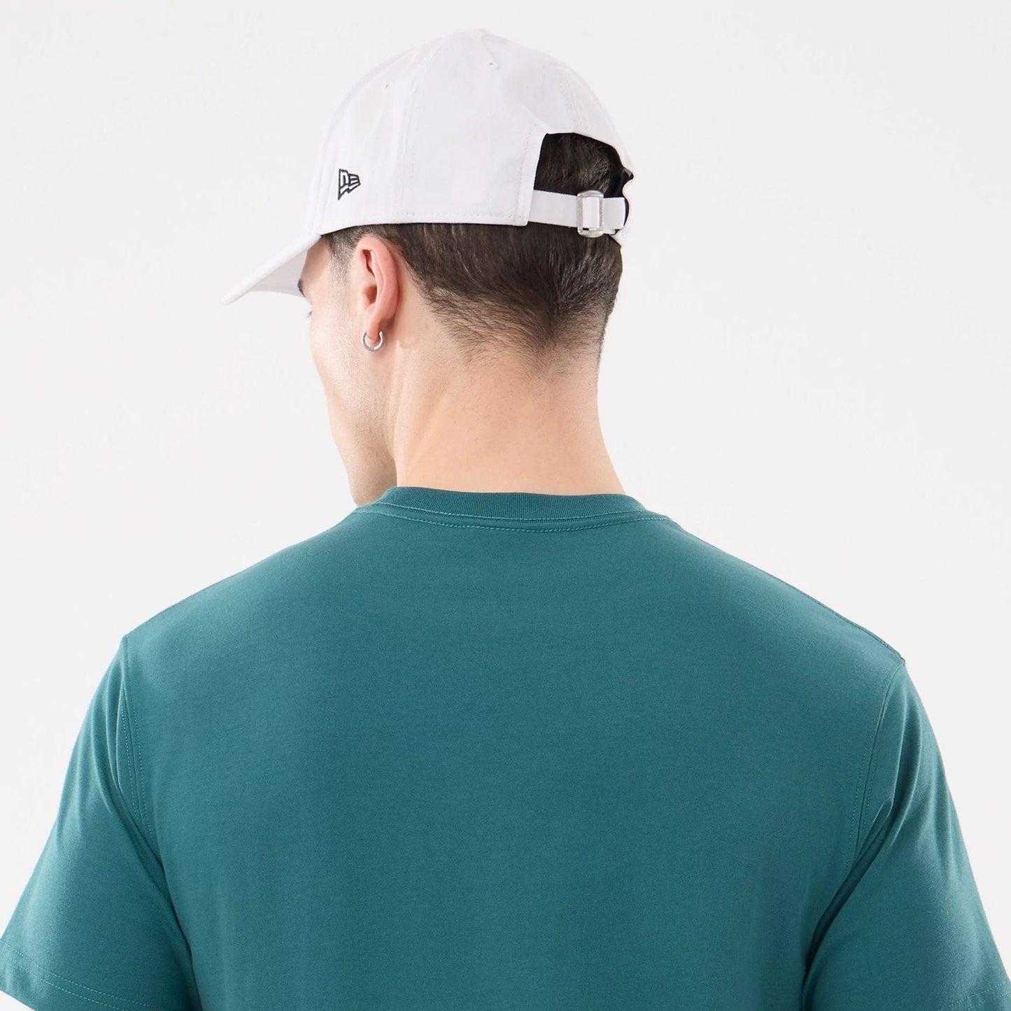 The model is wearing this New Era SK8 Graphic T-Shirt in dark green. 6