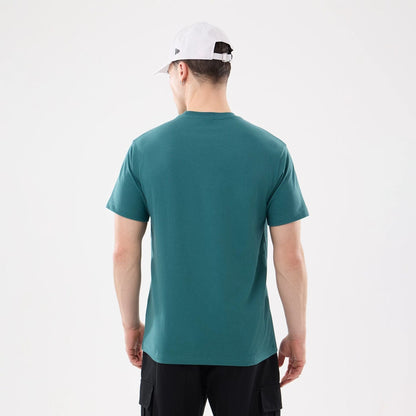 The model is wearing this New Era SK8 Graphic T-Shirt in dark green. 2