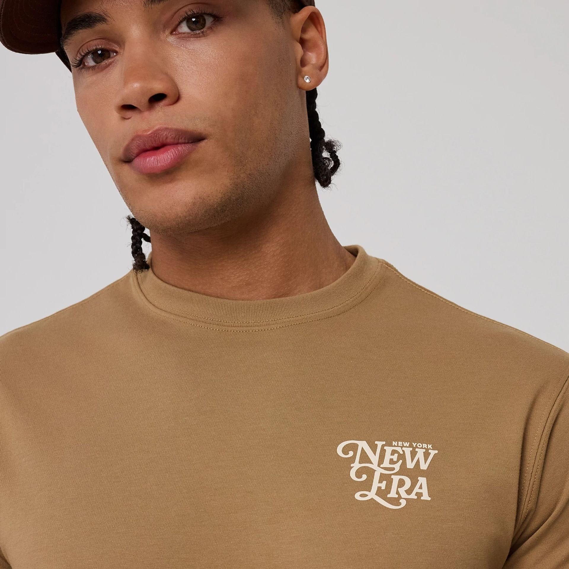 The model is wearing this New Era Script Graphic T-Shirt in Beige. 7