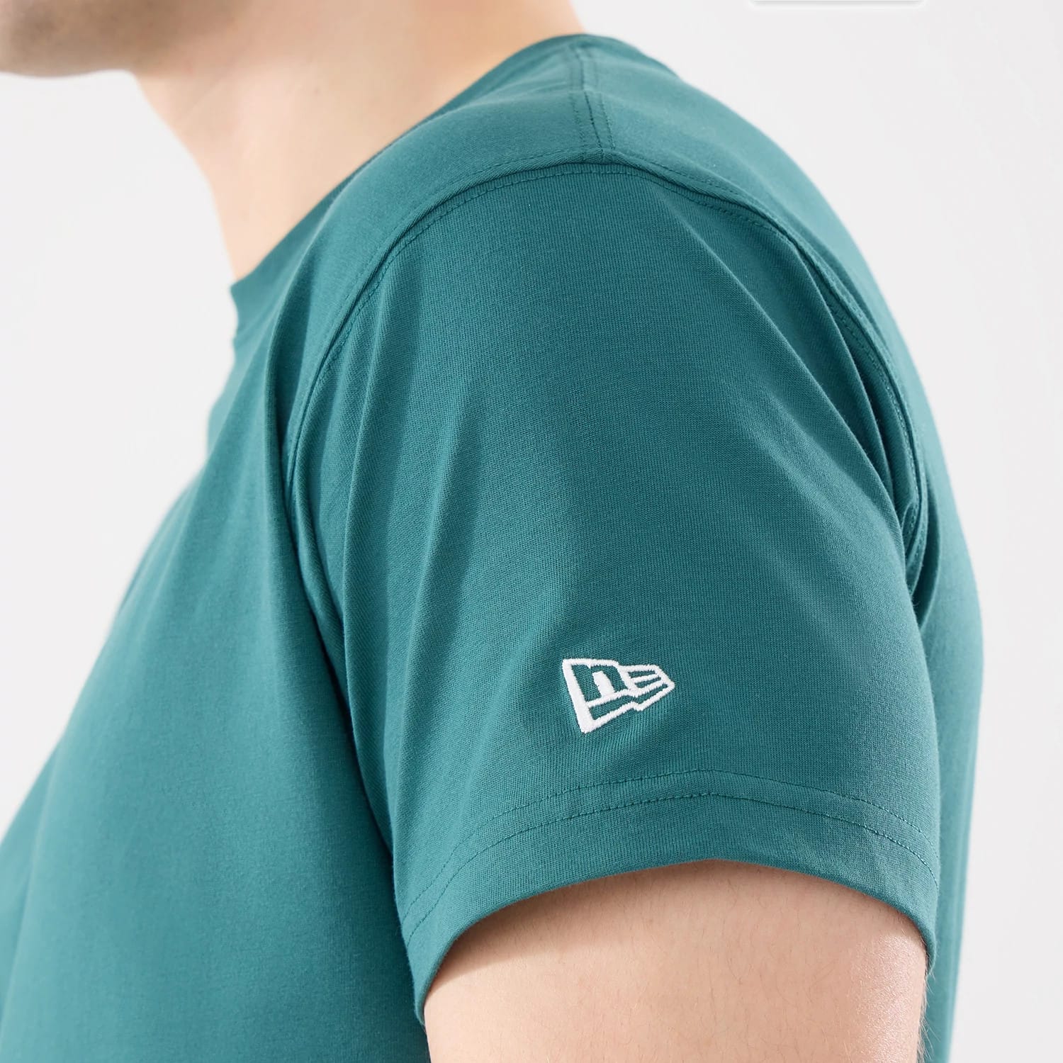 The model is wearing this New Era Earth Day T-Shirt in dark green. 4