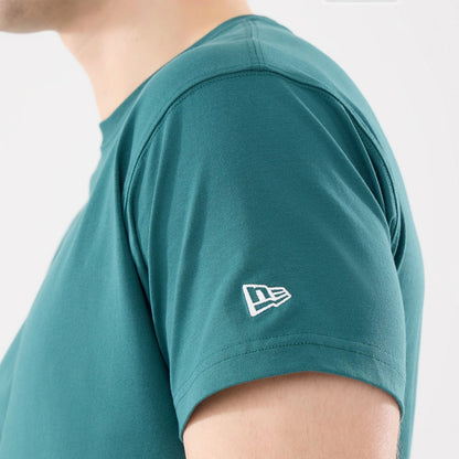 New Era Earth Day Dark Green T-Shirt, side view showing the short sleeve with a white embroidered New Era logo on the upper left arm and a smooth neckline, highlighting the rich dark green fabric.