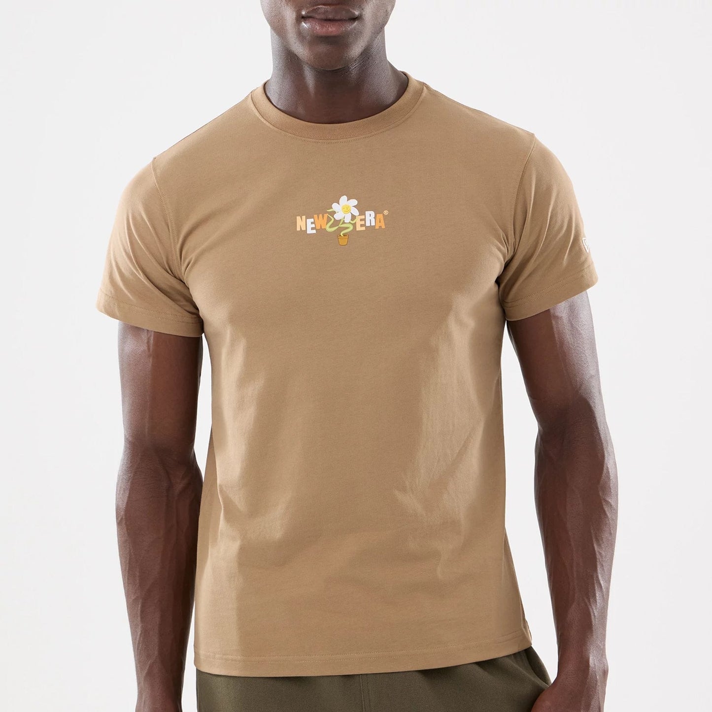 The model is wearing this New Era Earth Day T-Shirt in beige/khaki. 5